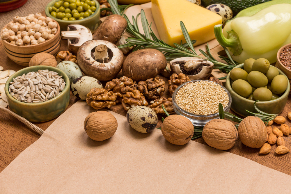 castanhas, sementes e cogumelos e outros alimentos em um fundo de madeira - legumes de inverno - Assaí Atacadista